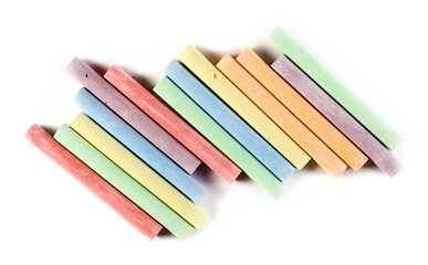 Colorful chalks pile isolated on white background, top view