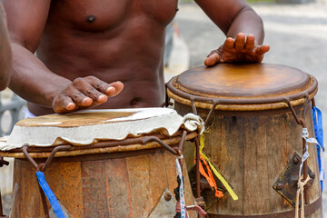 Musician playing atabaque which is a percussion instrument of African origin used in samba,...