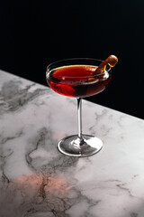 glass of boulevardier on black background