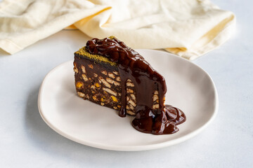 Mosaic cake with chocolate sauce on a white background