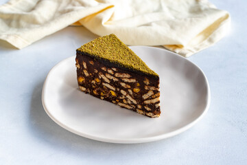 Pistachio mosaic cake on a white background