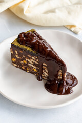 Mosaic cake with chocolate sauce on a white background