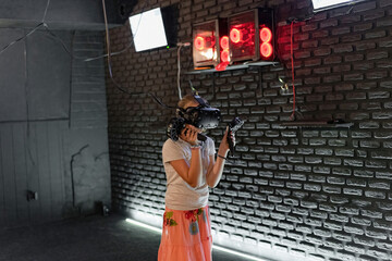 The girl in the VR helmet plays computer games.