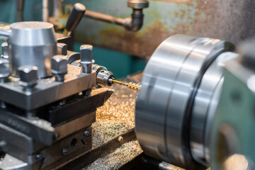 Making nuts from a bronze hexagon on a lathe.