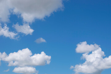 White clouds against a blue sky. Good daylight weather copy space for text