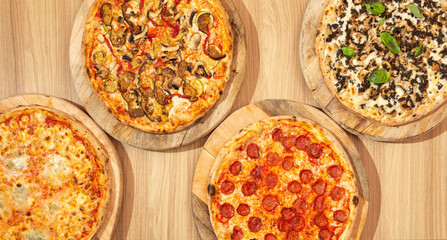 Assorted pizzas on wood, vegetarian, spicy sausage, truffle and mushroom, margherita.