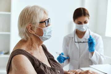 elderly woman wearing a medical mask immunization safety health care
