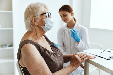 elderly woman wearing a medical mask immunization safety immunity protection