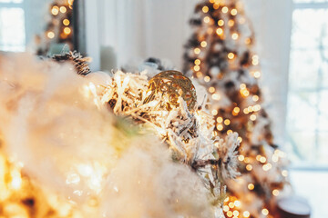 Classic christmas New Year decorated interior room New year tree. Christmas tree with gold decorations and gift boxes. Modern white classical style interior design apartment. Christmas eve at home.