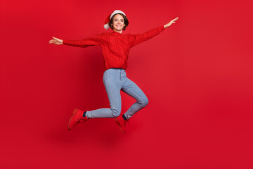 Fototapeta na wymiar Full body photo of young excited girl happy positive smile jumper holiday noel isolated over red color background
