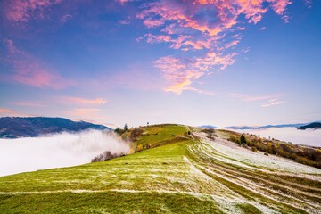 Frozen road against the backdrop of a beautiful sky and fluffy fog