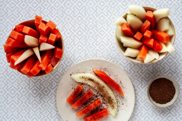 Fresh fruit snack with spicy chili and cocoa condiment powder.