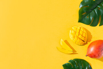 Creative layout made of ripe juicy mango on yellow background. Flat lay, top view, copy space, product place. Healthy food concept, dieting. Food, organic cosmetics background. Summer banner