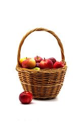 Basket of fresh, ripe apples on white. Various red and green apple fruits in wicker basket.	