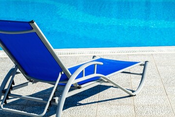 Fototapeta na wymiar Blue Pool Chair beside Pool