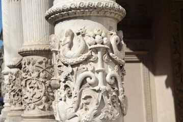 Fototapeta na wymiar Baroque bas-reliefs and ornaments on the columns of a church in northern Italy