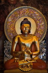 Fototapeta na wymiar Golden Buddha statue on abstract dark background. religion art national concept. Buddhism culture symbol. spiritual relax
