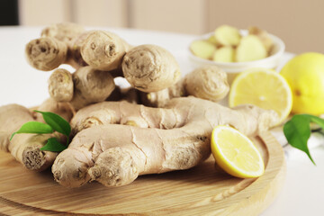 Autumn harvest, Fresh ginger root and lemon on the background of the kitchen at home. Fresh ginger on the kitchen table. Natural medicine. Immunity and health.
