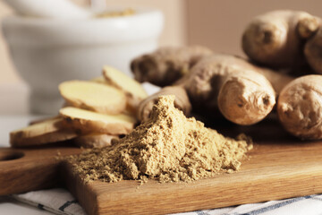 Ground ginger in a mortar, fresh ginger in the background, ginger pieces in a bowl. Spice for recipes. Ginger on the board. Health and immunity for the winter. Autumn harvesting.