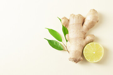 Composition of fresh ginger root with lime on the background.