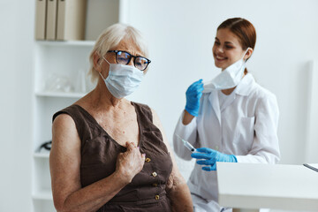 old woman wearing medical mask in the hospital for vaccinations vaccine passport