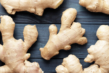 Composition of ginger root on a blue wooden background.
