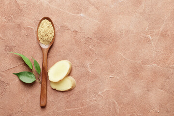 Wooden spoon full of dry ginger on textured background