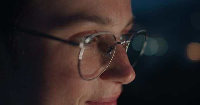 Close up portrait of authentic young millennial woman with screen lit face and sunglasses. Excited happy facial expression, candid emotions of new generation z using technology. Scroll on phone screen