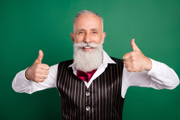 Photo of positive well-dressed man raise thumbs up wear formalwear striped waistcoat on green color background