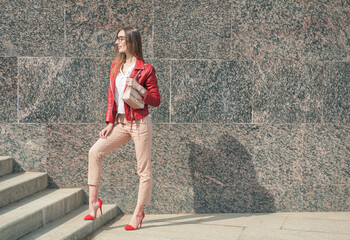 Beautiful young fashion stylish woman with red jacket