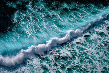 Aerial view to seething waves with foam. Waves of the sea meet each other during high tide and low tide