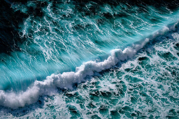 Aerial view to seething waves with foam. Waves of the sea meet each other during high tide and low...