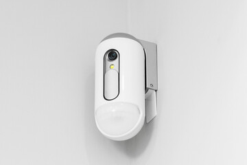 Surveillance camera with presence sensor on the wall - obrazy, fototapety, plakaty