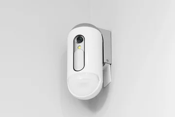 Fotobehang Surveillance camera with presence sensor on the wall © claudiovaldes