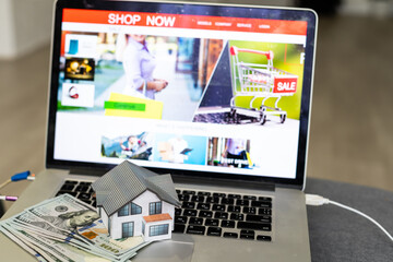 Laptop and dollar bill for Shopping online, home model