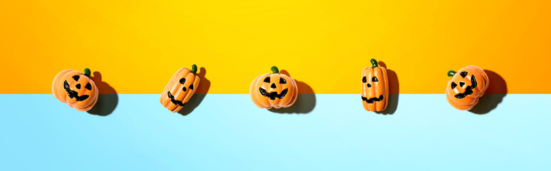 Miniature Halloween pumpkin ghosts - overhead view flat lay