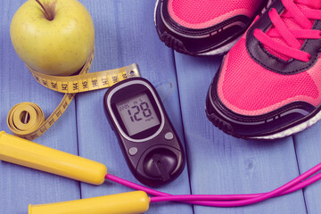 Fototapeta na wymiar Glucose meter with sugar level, sport shoes and accessories for fitness. Diabetes and healthy sporty lifestyles