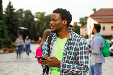 The young african student uses navigation on a smartphone
