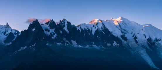 Panorama of the mountain peaks near Chamonix during a tranquil dawn.