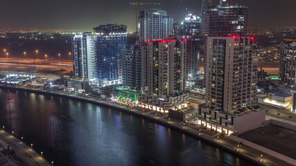 Fototapeta na wymiar Towers at the Business Bay aerial night timelapse in Dubai, United Arab Emirates