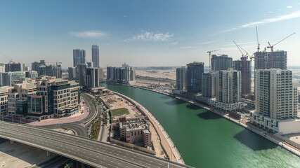 Fototapeta premium Skyscrapers at the Business Bay aerial all day timelapse in Dubai, United Arab Emirates