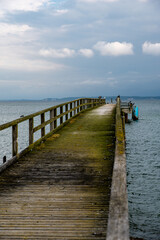 Naklejka premium View along an old jetty onto the Baltic Sea and a dramatic cloudy sky 