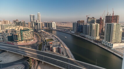 Fototapeta na wymiar Skyscrapers at the Business Bay aerial evening timelapse in Dubai, United Arab Emirates