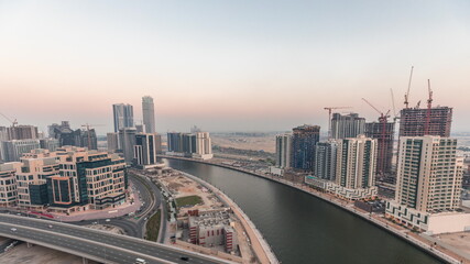 Fototapeta na wymiar Skyscrapers at the Business Bay aerial day to night timelapse in Dubai, United Arab Emirates