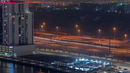 Fototapeta na wymiar Towers and road at the Business Bay aerial night timelapse in Dubai, United Arab Emirates
