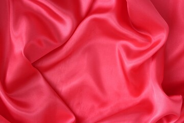 Delicate red fabric with beautiful pleats. Silk, satin are folded freely. It can serve as a background for the inscription.