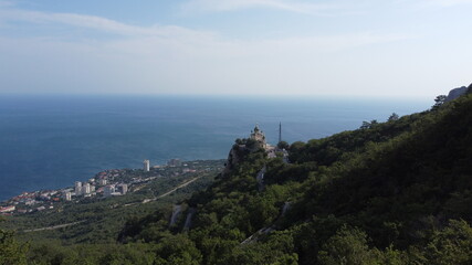 Fototapeta na wymiar view of the temple on a ledge in the mountains, the sea and the city from a mountain in the Crimea