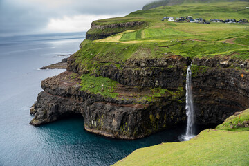 Beautiful aerial view of Gasadalur waterfall and village and landscapes in the Faroe Islands