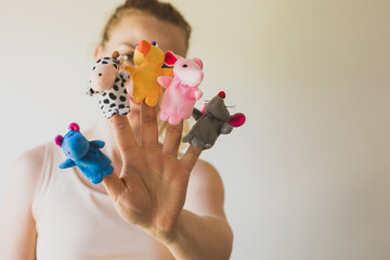 Woman hand wearing five finger puppets close up