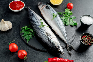 raw mackerel with spices on a stone background
